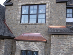 04. Through-wall masonry flashing on bay window, rake ledger, and head wall ledger