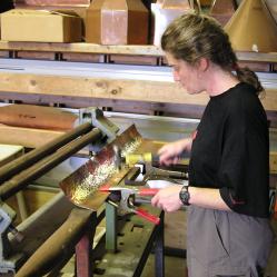 Natalie Hines annealing some copper trim for a stove vent hood.