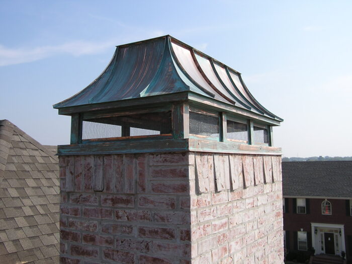 french curve copper chimney cap with patina finish